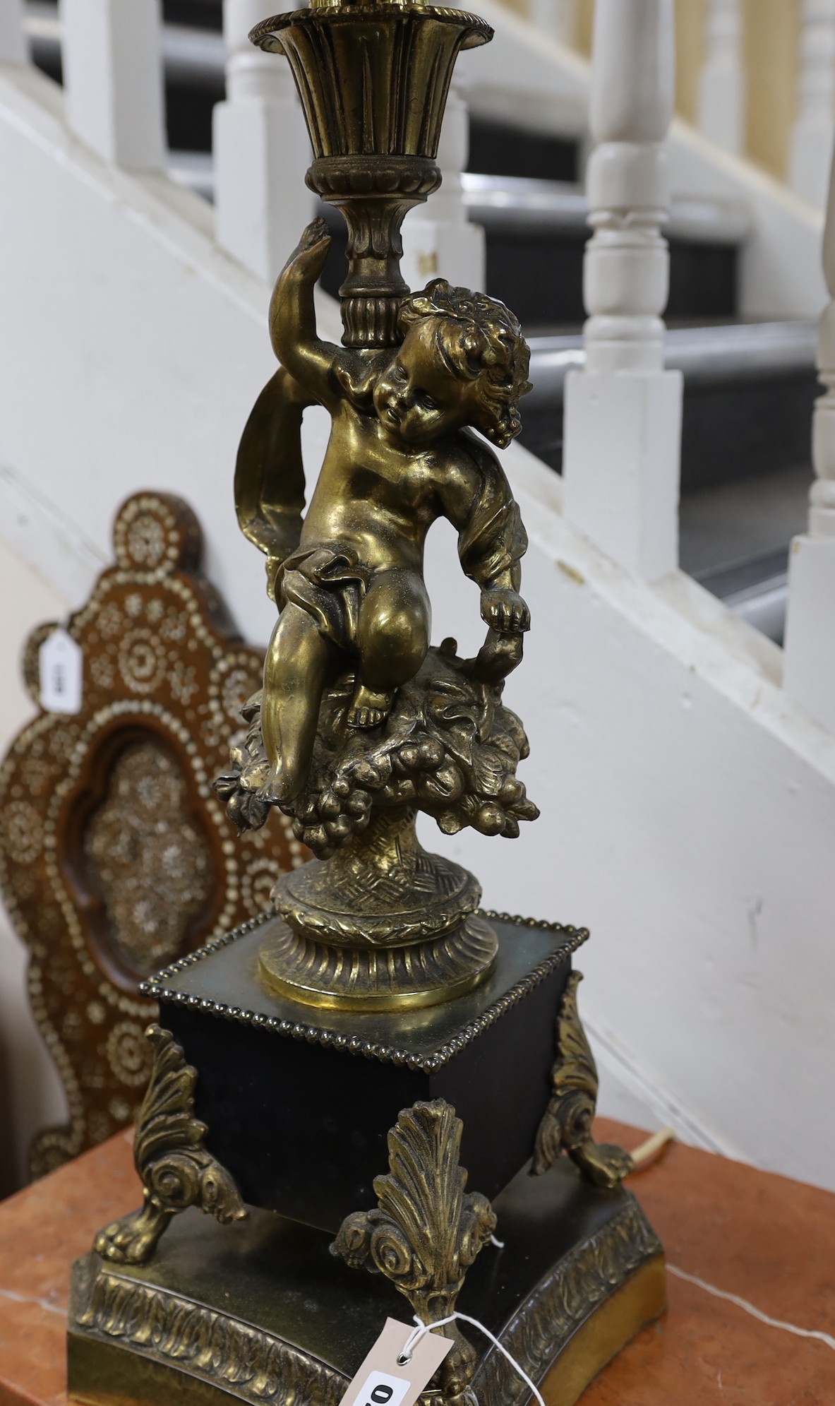 A large cherub stem cast brass five light table lamp with shade, 99cms high including shade
